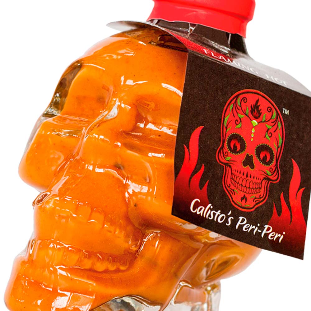 skullflaming zoom sml Calisto’s Skull Peri-Peri Sauce - Flaming Hot - ultra-spicy peri-peri sauce for heat lovers. Close up.
